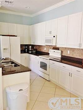 Kitchen, food cabinets have roll out drawers.