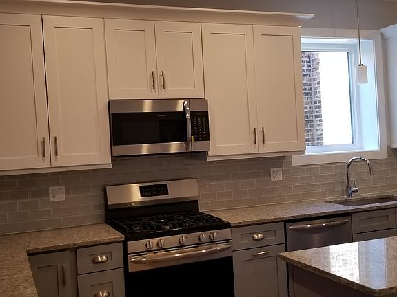 Large kitchen with lots of cabinets, oversize island and new appliances