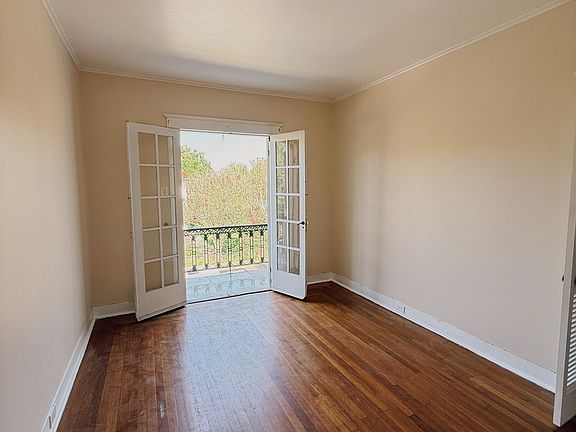spacious living room with french doors that open to private balcony.