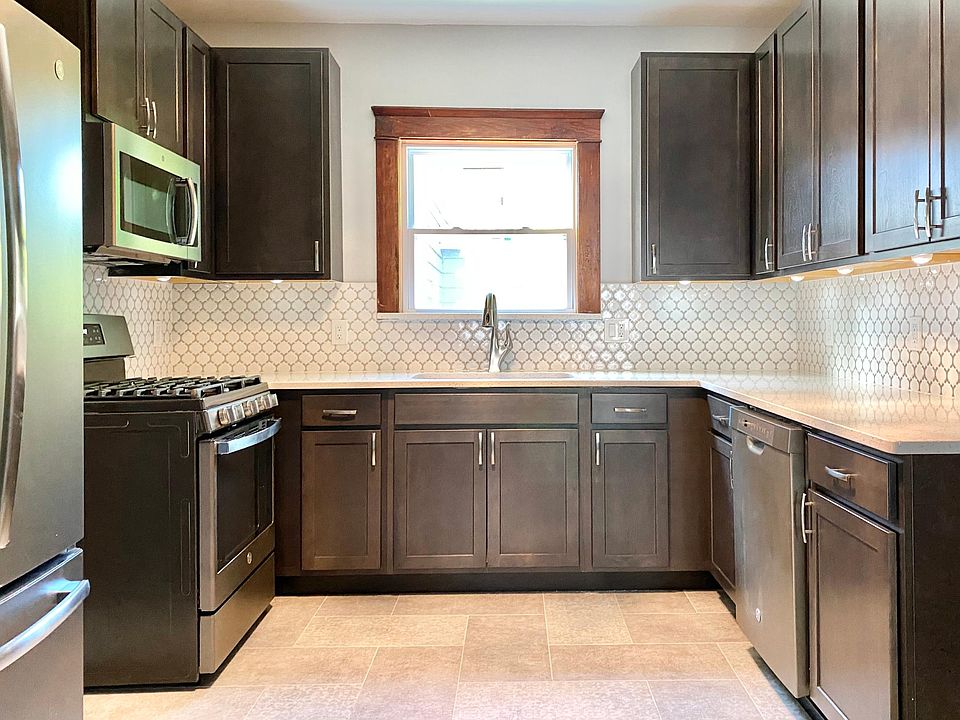 Professionally designed kitchen: hardwood cabinets, quartz counters, custom tile backsplash, Slate appliances including dishwasher