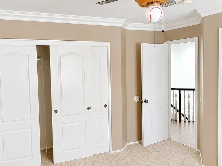 Spacious bedroom with closet access and ensuite bathroom entry