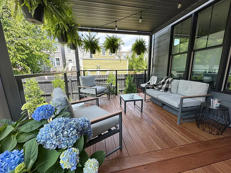 Covered hardwood deck off the family room creates great outdoor living space. Roof louvers open for additional sunlight.