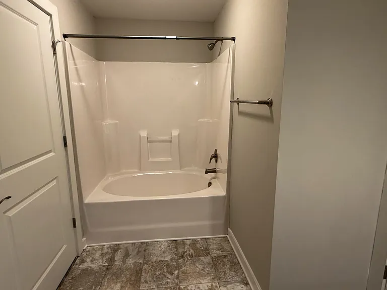 The bathroom features a spacious garden tub.