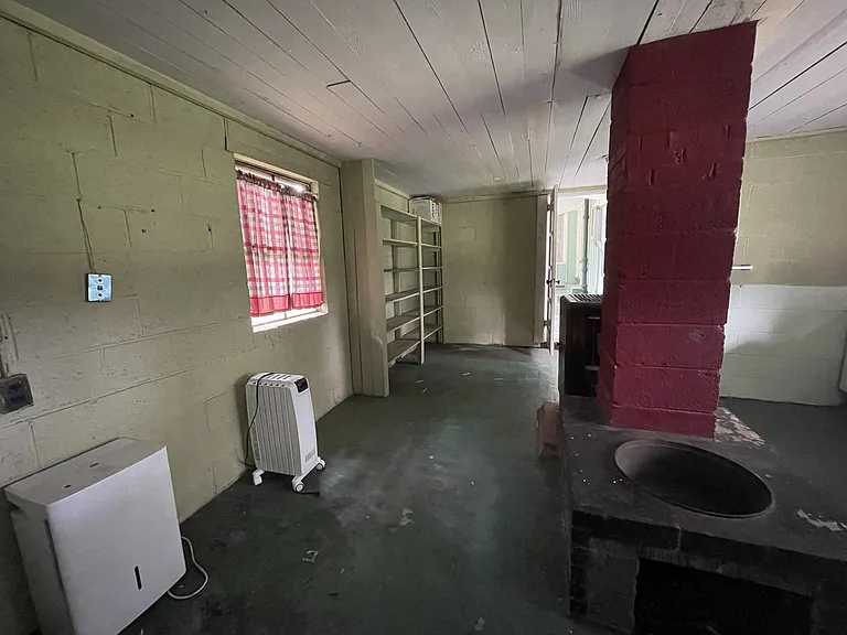 Attached mudroom, featuring plenty of storage space, a vintage farmhouse sink, laundry hook-ups and a rustic, full bathroom.