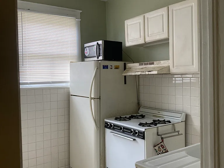 Kitchen with gas stove/oven, fridge and microwave