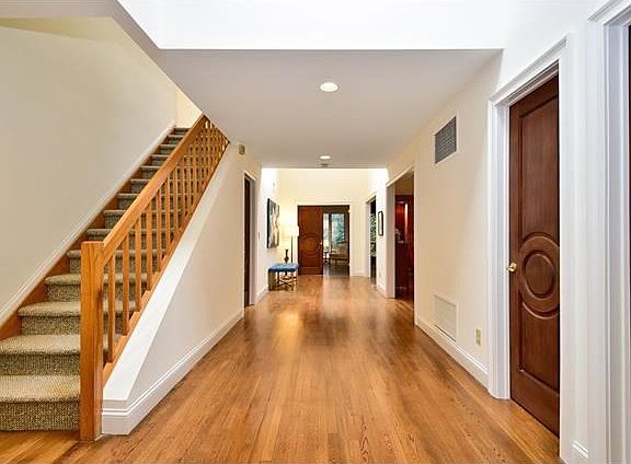 Entrance foyer and gallery with gleaming hardwood floors.