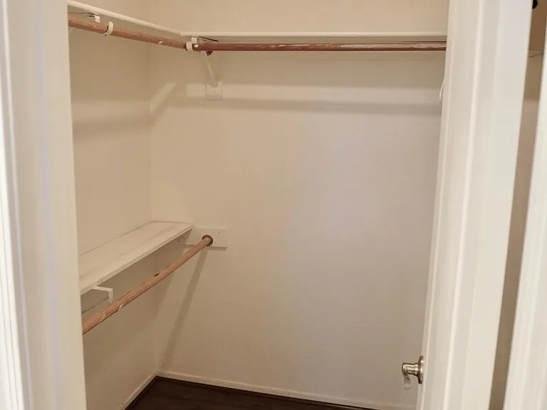 Master bedroom walk-in closet with upgraded flooring.