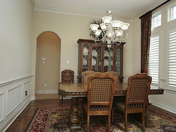 Formal dining room with hardwood floors and Plantation shutters.