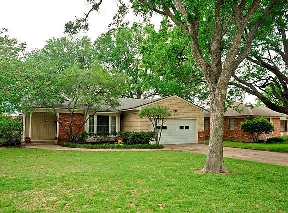 Charming Richardson Heights home with large trees in the front and back.