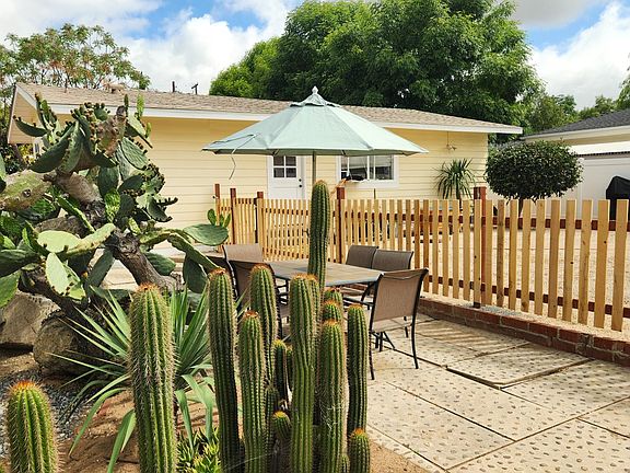 Part of the common area with the apartment in the bacground - table and chairs with an umbrella. Note the fences dedicated to the apartment.