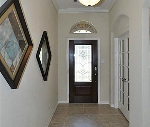 Mahogany and leaded glass door with tiled foyer.