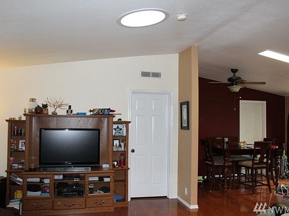 Partial view of the living room and the dining area. Door straight ahead leads to the master bedroom. 