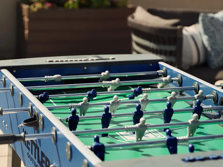 Challenge friends to a foosball match on the rooftop terrace, where friendly competition meets open skies and city views.