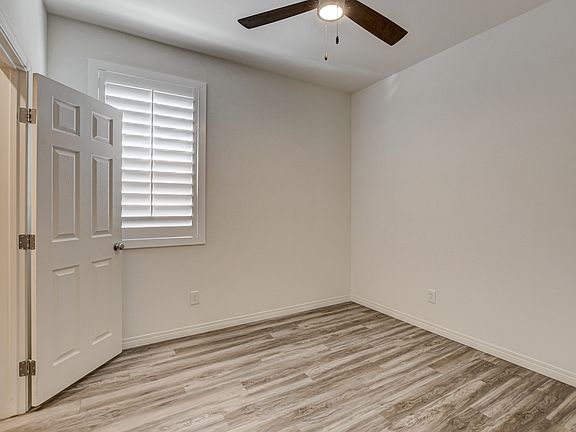 Downstairs bedroom with ceiling fan