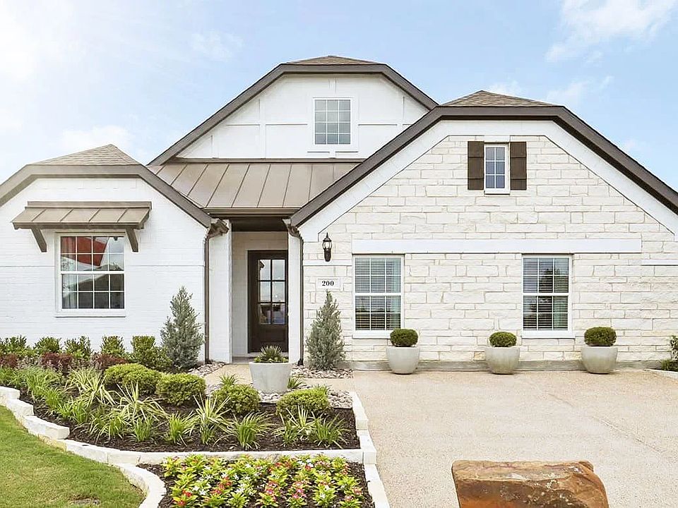 Impeccable stone facade and gabled roof combine in this sophisticated Thompson Farms residence.