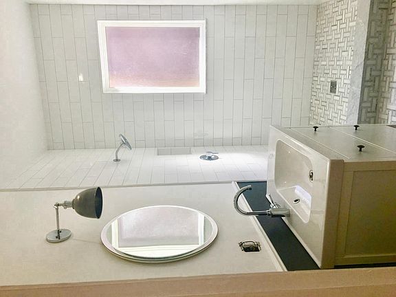 Newly renovated bathroom with walk in shower and marble tile