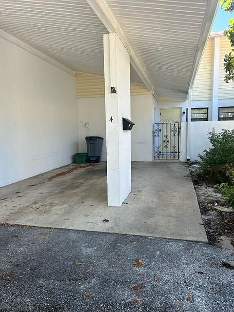 Covered single car carport and entrance to home.