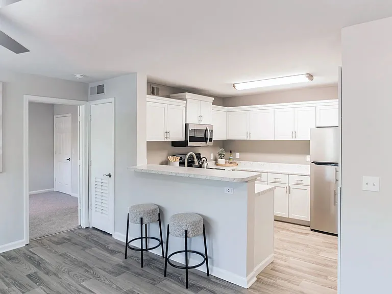 Indulge living in this stunning kitchen oasis boasting ample cabinetry and a versatile breakfast bar overlooking the living area for the ultimate in convenience and style.