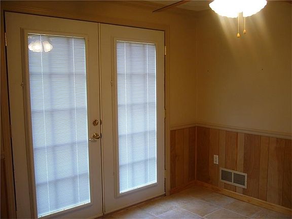 Other side of kitchen with French doors to a deck an backyard.