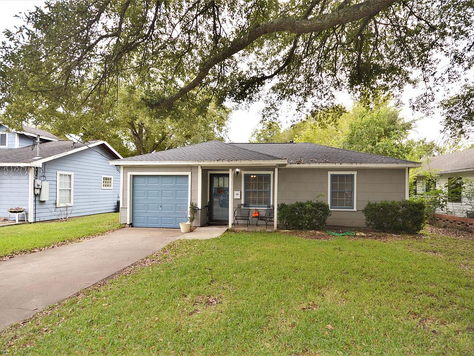 Charming exterior with porch and large mature trees