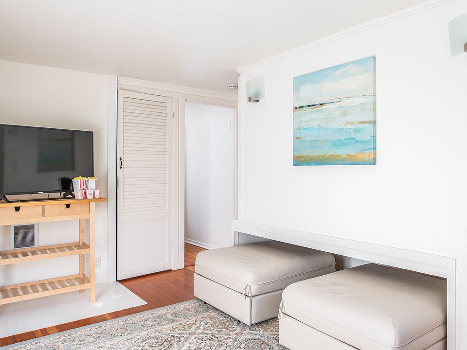 Another view of bedroom with ottomans closed. Ottomans then open to make full-size bed.