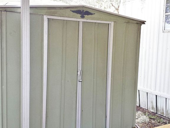 STORAGE SHED BY CARPORT