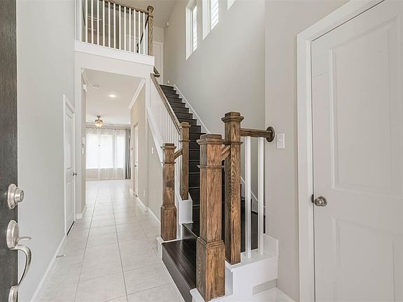 Light and bright with plenty of natural light flowing into the home. The foyer has a open ceiling, tile and laminate flooring.