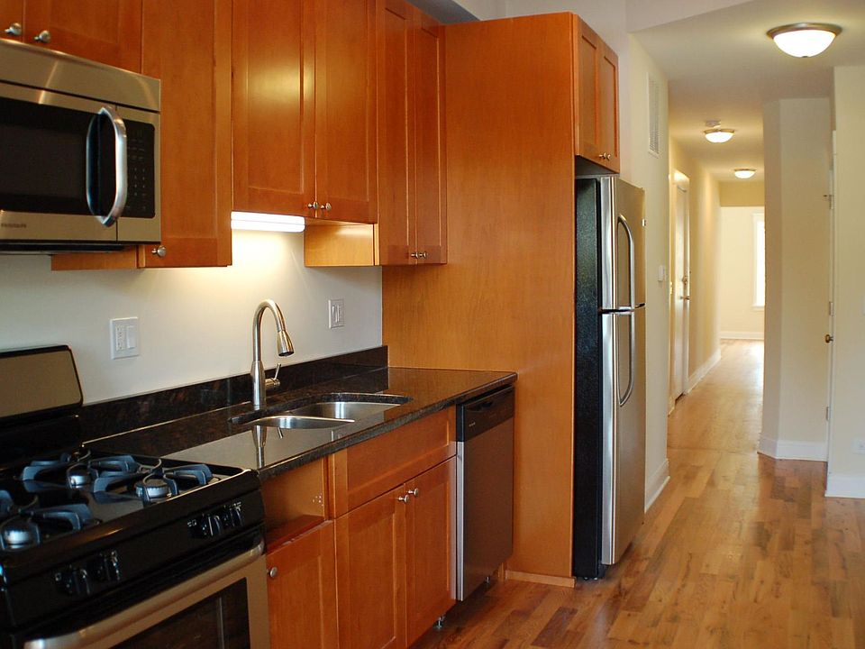 Kitchen with new stainless steel appliances and granite countertops.