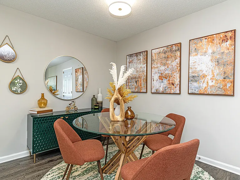 Dining area with hardwood-style flooring and overhead lighting