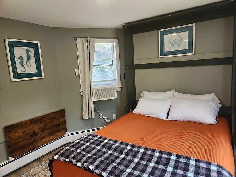 Bedroom 3 with queen bed on second floor, separate entrance, mini-fridge, mircowave, smart TV, fold away table and chairs, shower stall, bathroom sink, toilet, and views of backyard.