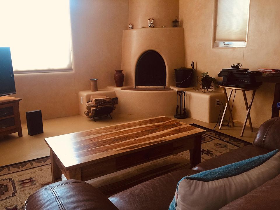 Wood burning Kiva, Leather sofa and chair, Plasma TV and stereo.