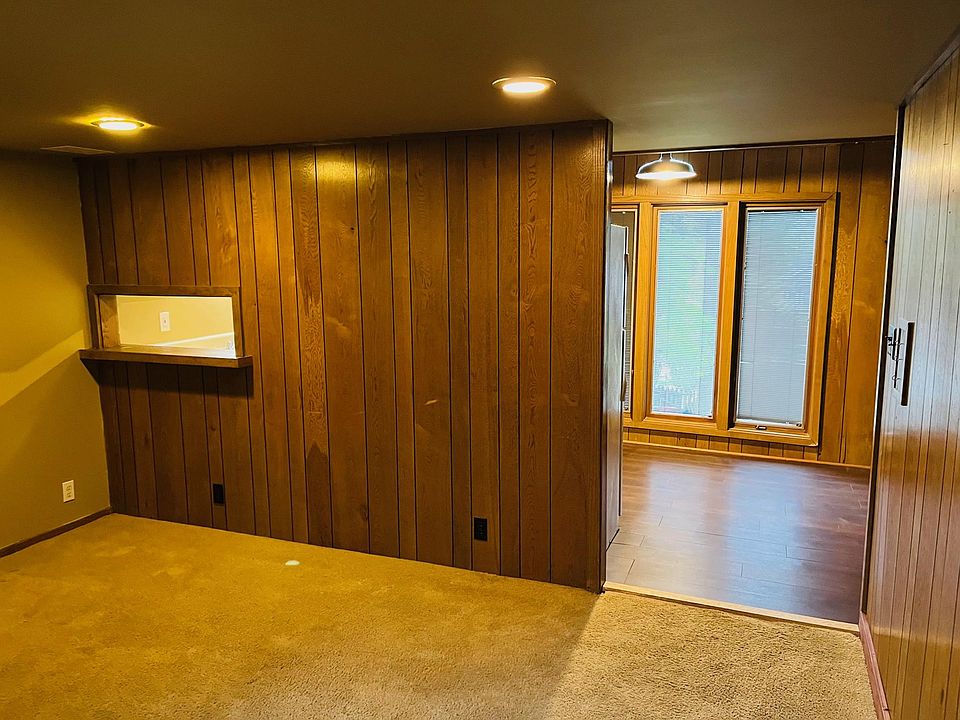 Down stairs living area looking from front door. Kitchen, bathroom, and bedroom located to the right.