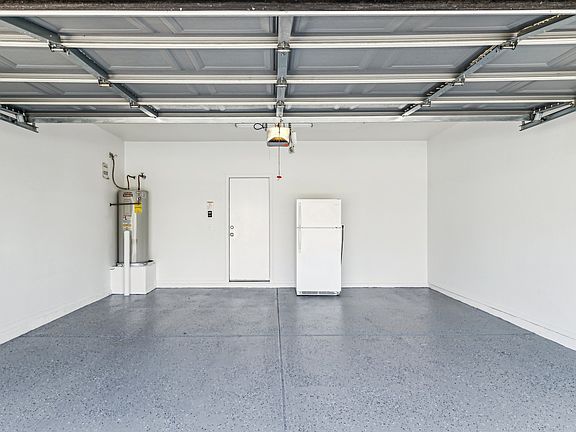 nice 2 car garage with a extra refridgerator for food storage and freezer. Floor was just freshly painted epoxy.