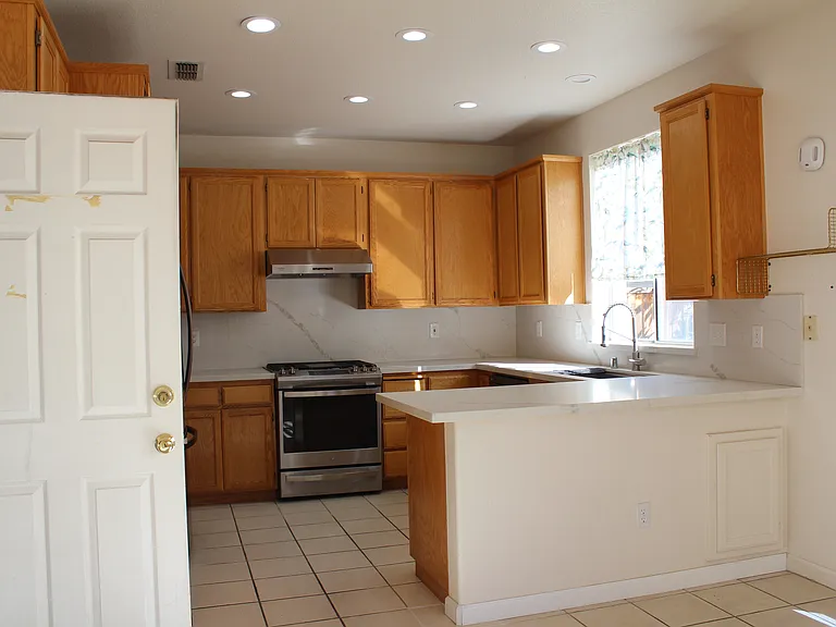 kitchen and the door leads to the garage, the other door leads to the backyard