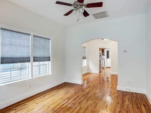 Greeted with tall ceilings that brings lots of natural light that shine off these solid hardwood floors, the arch is one of the many custom features throughout this home.