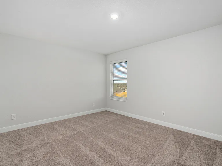 Each additional bedroom features lush carpet flooring.