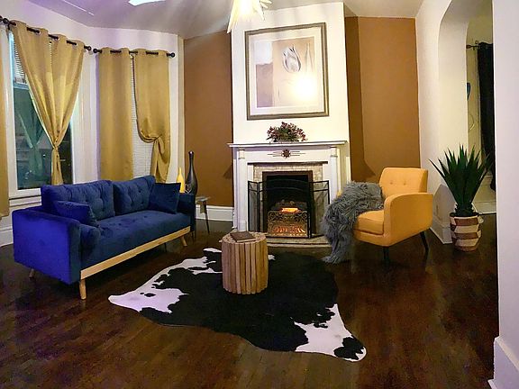 Living room has voice controlled fireplace and real hardwood flooring