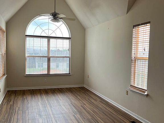 Large primary bedroom with windows on 3 walls to let in lets of light. New flooring and freshly painted.