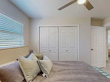 Cozy private room with hardwood-style floors, ceiling fan, and tasteful decor, ready for immediate move-in