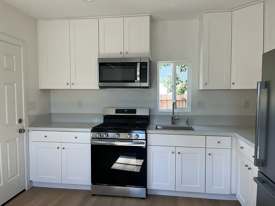 Renovated kitchen with stainless steel appliances and quartz countertops