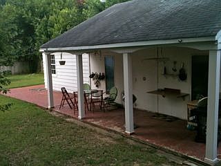 garage with porch, ceiling fan, BBQ area, and AC