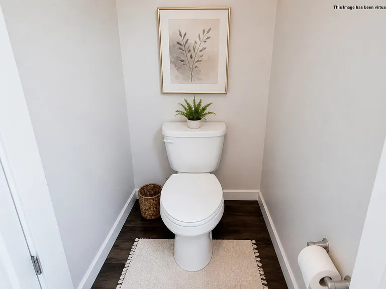 Half bath on main level, virtually staged.