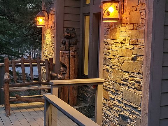 Exterior of Home updraded with real stone decor and lighted paver driveway