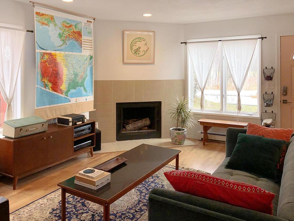 Enchanting living room. Wall mounted TV behind the pull down map. natural light fills this room from sunrise through the afternoon.