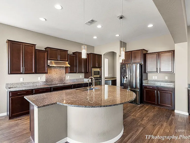 Island has SS sink, reverse osmosis water filtration, handy area for crafts or eating, rollouts for some lower cabinets, dishwasher
