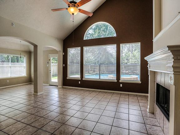 Wall of windows in family overlook fun backyard.