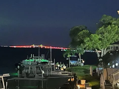 View of the iconic Skyway Bridge lit up at night