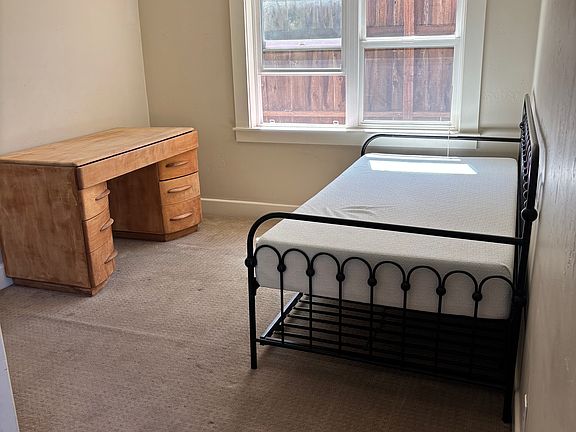 Bed room with fire exit door, the furnishings are a option and can easily be removed. Window shade is full coverage but not black out . 4 electrical outlets in this room