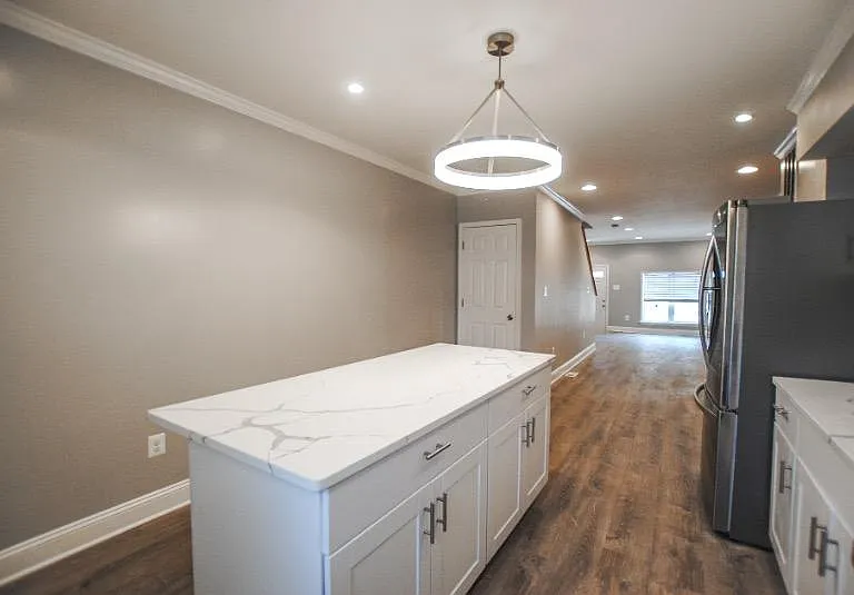 Walk in to an open first level; head to the back of the house to find the upgraded kitchen