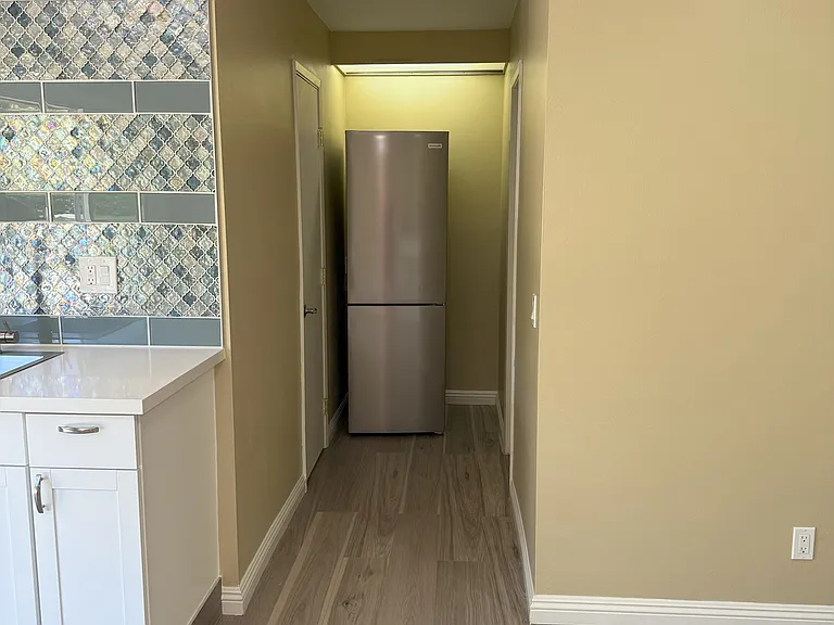 Refrigerator in the hallway, out of the way